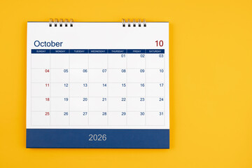 October 2026 desk calendar on the yellow table, planning for business meeting or planning concept.