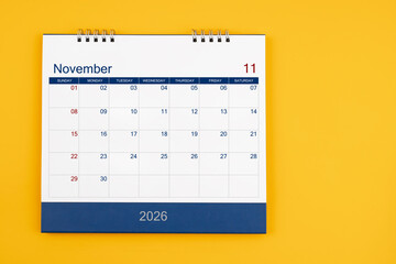 November 2026 desk calendar on the yellow table, planning for business meeting or planning concept.
