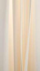 Fototapeta premium Cream-colored sheer curtains gently draped, creating soft light and shadow patterns in a minimalist interior setting.
