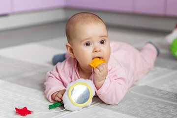 Baby with soft educational toy.