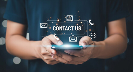 Person holding smartphone with contact us message and communication icons hovering above it