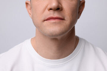 Clean shaven man on light background, closeup