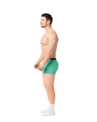 Young man in stylish turquoise underwear on white background