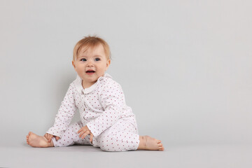 Cute little baby on light grey background, space for text