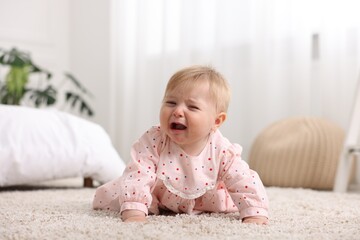 Fototapeta premium Cute little baby girl crying at home
