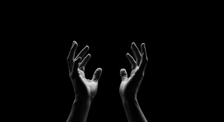Two hands reaching upwards against a stark black background, conveying a sense of yearning or supplication