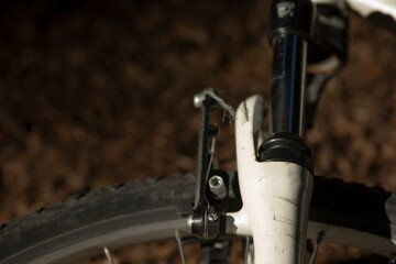 This is a detailed closeup view of a bicycle wheel that features a brake mechanism attached to it for stopping power