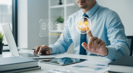 Man selecting the best rating on a digital interface with laptop and tablet on a white office desk