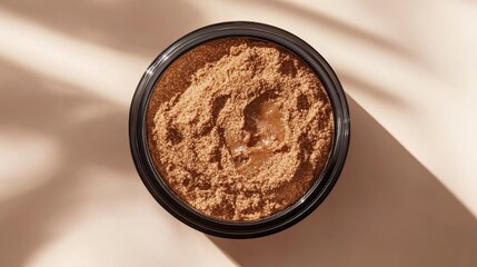 Brown Powder in Black Container Arranged on Light Surface