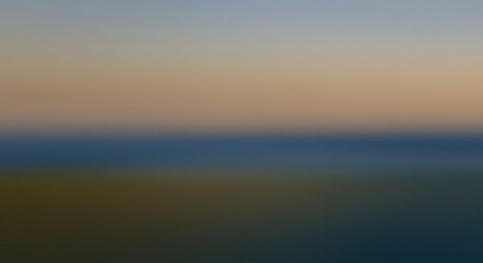 Obraz premium An abstract, blurred image with horizontal color bands of light blue, tan, dark blue, and dark brown, from top to bottom.
