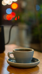 up of hot coffee or tea and teapot on wooden table with bokeh background