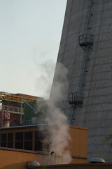Smoke is rising and emanating from the side of a building, suggesting some activity occurring...
