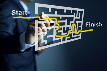 Business solution and problem solving guidance concept with businessman writing route in maze...