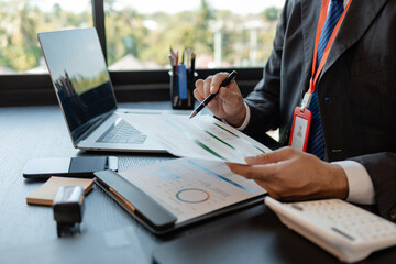 a businessman reviews the company's financial documents in his office, the accountant is rushing to...