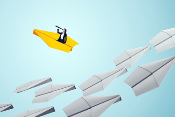 Businesswoman on yellow paper plane leading others, symbolizing leadership, vision, and ambition in...