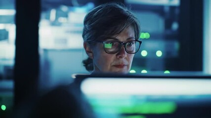 Woman in glasses works in a server room with digital reflection on screen - Powered by Adobe