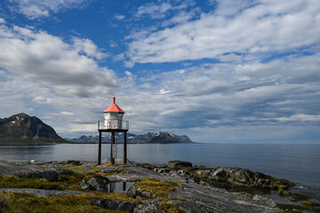 Small lighthouse on the shore by the sea 