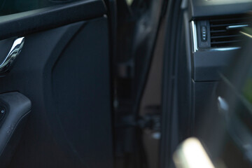 This is a close up view showcasing the inside of a car, with the door wide open, inviting a glimpse into its interior design elements