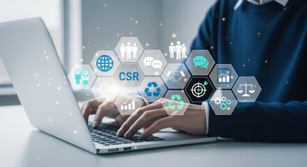 Person typing on laptop with csr and sustainability icons overlaid on the screen and keyboard area