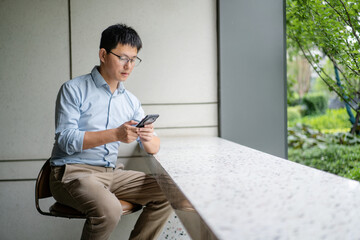 asian businessman working on smart phone