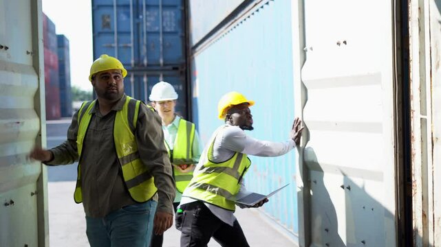 Group of diversity engineering and logistic dock worker opening Container box meeting inside and taking to checking goods inventory at Shipping Cargo Container Terminal Depot or warehouse storage