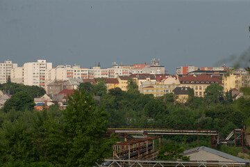 In a bustling city, there are numerous tall buildings rising above, with lush green trees visible...