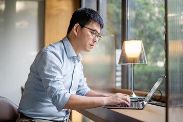 asian businessman working on laptop
