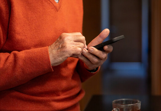Senior Man Using Smartphone at Home