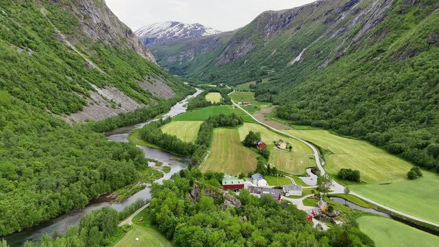 Aerial view of the lush Eikesdal valley with rivers, farmland, and mountain in Eikesdalen, Norway