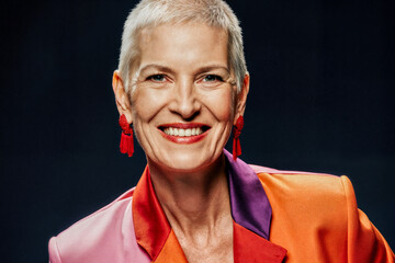 A confident and vibrant portrait of a smiling woman with short hair