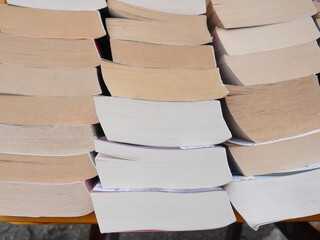 A stack of books with the top one being the thickest