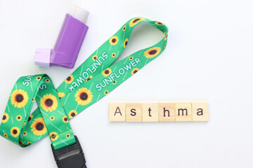 Hidden disability lanyard with a asthma device in a light background