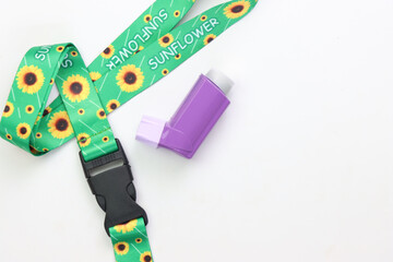 Hidden disability lanyard with a asthma device in a light background