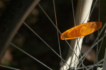 This is a detailed closeup image showcasing a bicycle wheel, which prominently features a reflector...