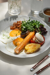 Portion of gourmet breakfast with sausage and fried eggs