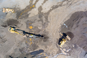 Excavators loaders work diligently in construction site to manage soil aggregate for building...