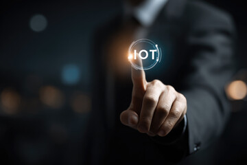 Smart business IOT, internet of things concept. Businessman touching IOT icon on virtual screen, connected internet network to access AI intelligence