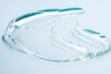 A large drop of collagen serum texture on a white background. Close-up, macro photography.