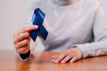 Awareness campaign blue ribbon significance community center indoor close-up health advocacy