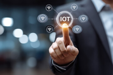 Smart business IOT, internet of things concept. Businessman touching IOT icon on virtual screen, connected internet network to access AI intelligence, business analytics, internet investing
