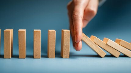 Professional Risk Management, Strategy to Stop Domino Effect in Business World, Crisis Prevention and Insurance Concept Visualized with Wooden Blocks and Human Hand