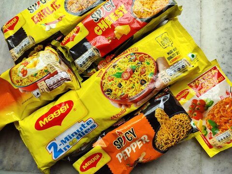 25th May 2025, Kolkata, India - Famous 2 Minutes quick noodles company brand Maggi, owned by Nestle, colorful food Package display after delivery.