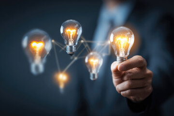 Businessman holding creative light bulb with smart business ideas innovation and inspiration concept