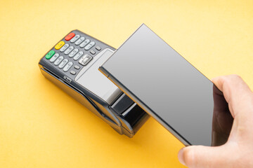 Contactless smartphone payment at the terminal for close-up payment. Non-cash payment by phone.
