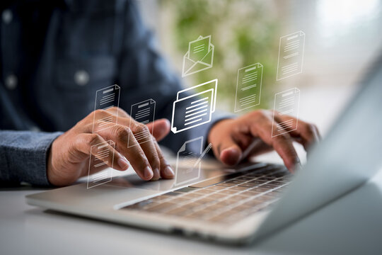 Businessman checks digital document on laptop with document management, approval process, representing paperless workflow, modern business operation, business automation and financial ecosystem.