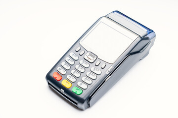 A black credit card reader with a green button on the top. The device is sitting on a white background