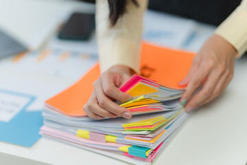 Woman Organizing Documents with Colorful Tabs