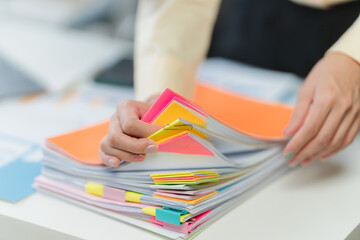 Hands Organizing Colorful Documents