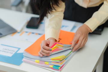 Businesswoman Organizing Documents in Office