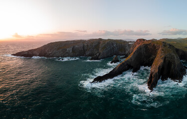Aerial views of beautiful coastal rocky outcrops at sunset and their drama